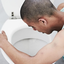 Image of man over toilet bowl